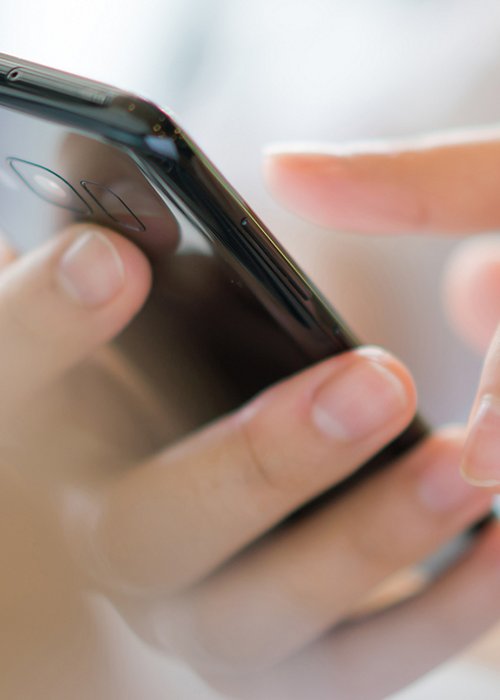 Business hand with mobile phone .