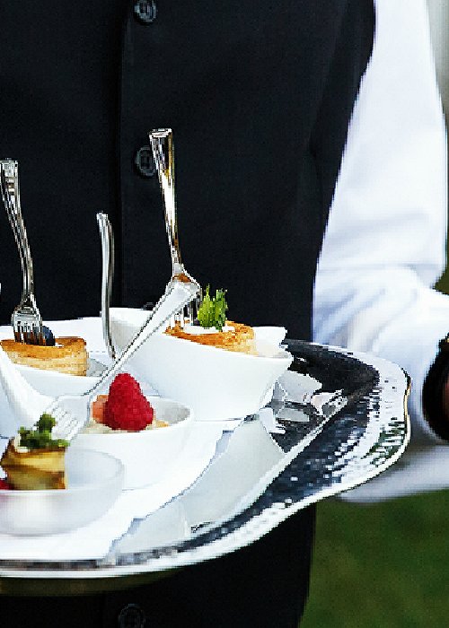 Waiter carries plate with tasty snacks Waiter carries plate with tasty snacks
