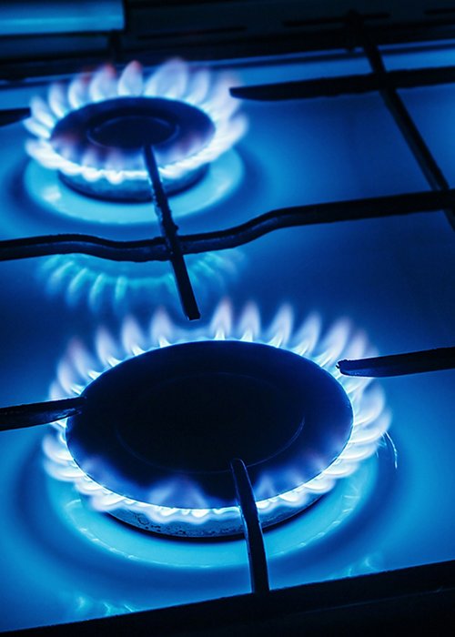 Blue flames of gas burning from a kitchen gas stove Blue flames of gas burning from a kitchen gas stove