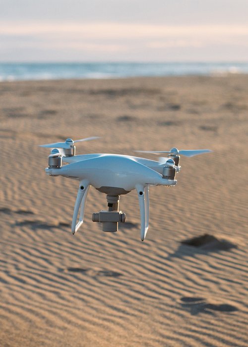 Aerial private drone lands at sand on beach Aerial private drone lands at sand on beach