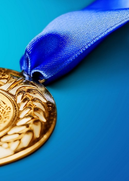 Gold medal with ribbon on background Gold medal with ribbon on background