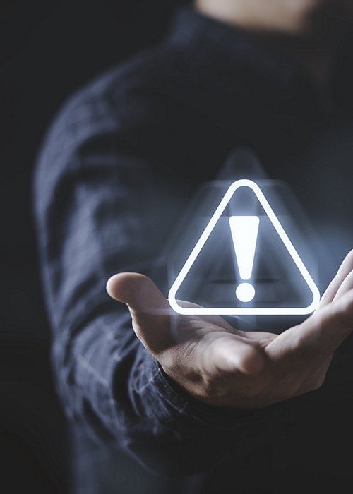 Businessman holding glowing of triangle caution warning exclamation sign for notification error and maintenance concept. Businessman holding glowing of triangle caution warning exclamation sign for notification error and maintenance concept.