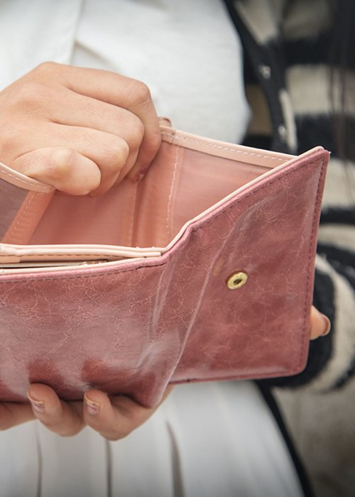 Young woman holding empty wallet. No Money Young woman holding empty wallet. No Money