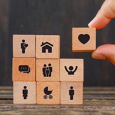Relationship concept on wooden background side view. hand holding wooden cube with heart icon. Relationship concept on wooden background side view. hand holding wooden cube with heart icon.