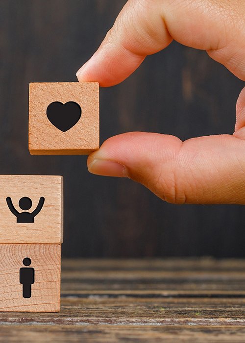 Relationship concept on wooden background side view. hand holding wooden cube with heart icon. Relationship concept on wooden background side view. hand holding wooden cube with heart icon.