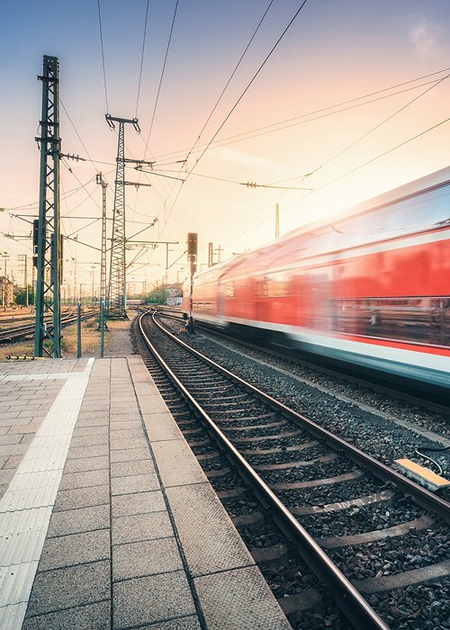 Red high speed train in motion on the railway station Red high speed train in motion on the railway station