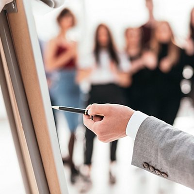 rear view . business man pointing with pen on a flipchart., rear view . business man pointing with pen on a flipchart. rear view . business man pointing with pen on a flipchart., rear view . business man pointing with pen on a flipchart.