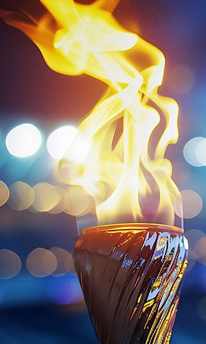 Burning torch close-up with broken background. Fire concept