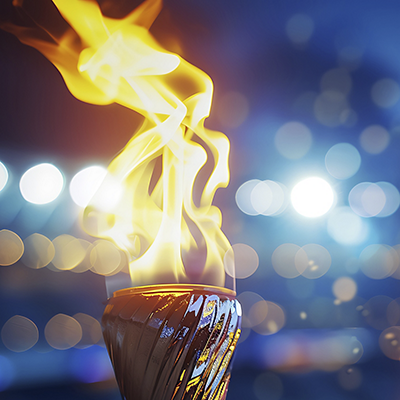 Burning torch close-up with broken background. Fire concept