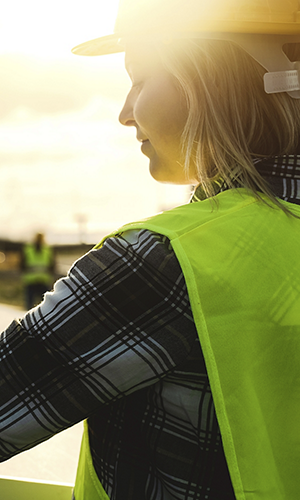 Young engineer working for alternative energy with wind turbine and solar panel - Innovation and green power concept 