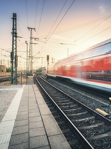 Red high speed train in motion on the railway station 