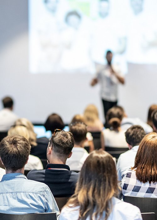 Male business speaker giving a talk at business conference event. Male business speaker giving a talk at business conference event.