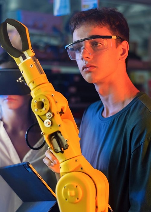 Teens remotely controlling robots in a laboratory