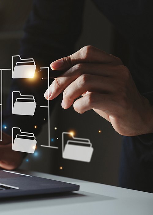 Businessman using a computer to document icons on virtual screen.