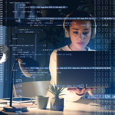 Program development concept. Young woman listening to music while working with laptop Program development concept. Young woman listening to music while working with laptop