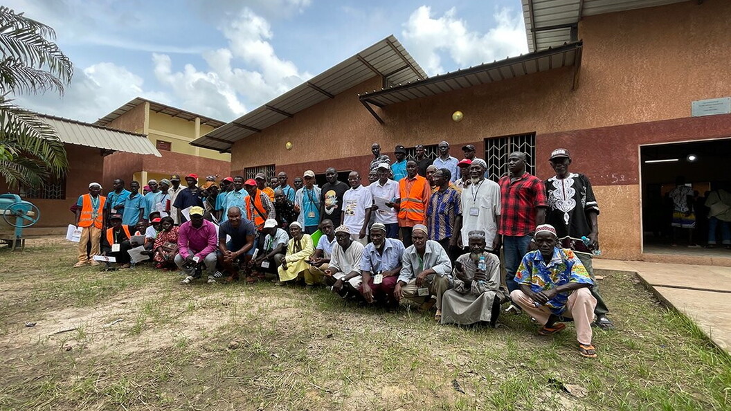 A group of people pose for a photo outside a building