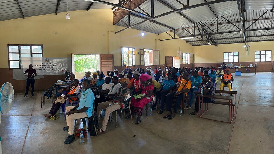 A group of people listen to a presentation in a classroom